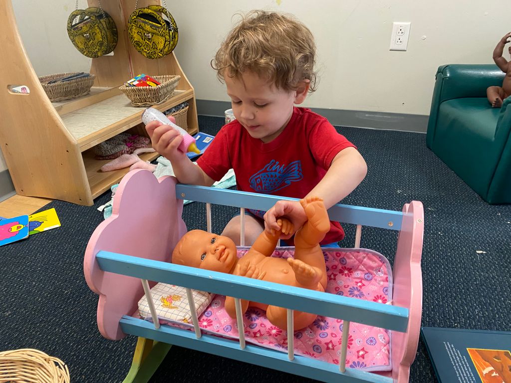 toddler caring for others doll play